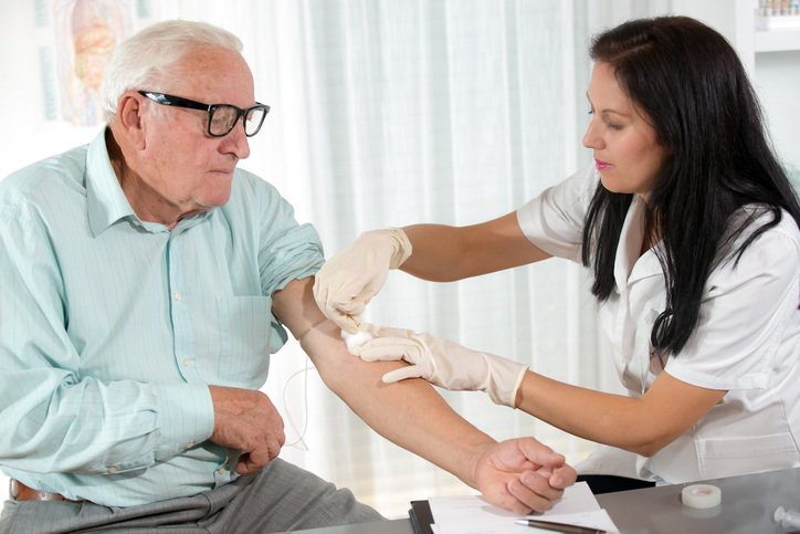 Blood sampling by an older man